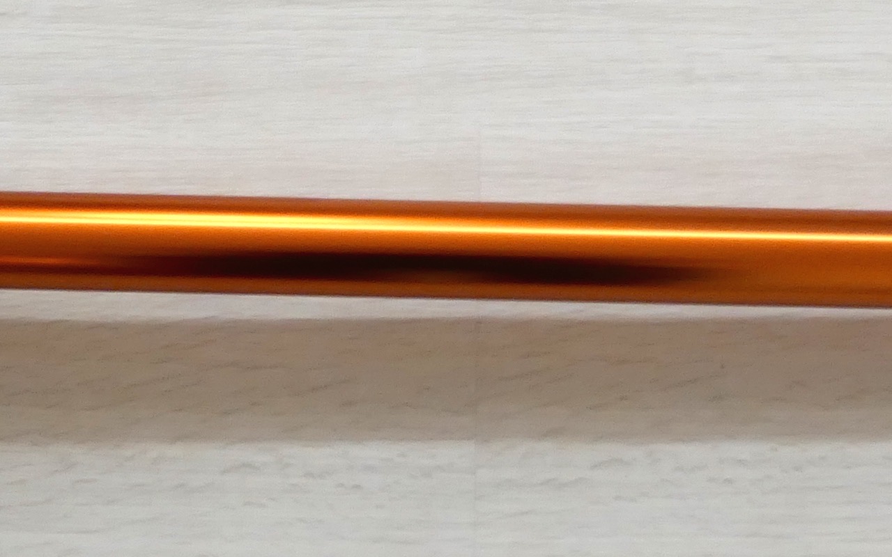 A cordless stick vacuum cleaner standing upright